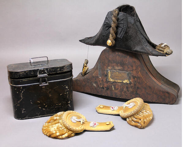 A Royal Navy officer's bicorne with tin transit case and associated cased pair of epaulets