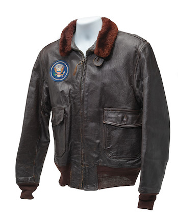 J.F.K.'S AIR FORCE ONE BOMBER JACKET GIVEN TO DAVID POWERS. An original U.S. Government issue G-1 flight jacket, with sewn patch of the Seal of the President of the United States over the right breast, originally owned by President John F. Kennedy and gifted to David Powers circa 1962-1963, image 1