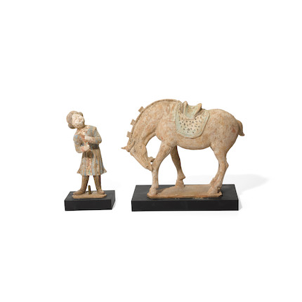 A PAINTED RED POTTERY GROOM AND A HORSE Tang dynasty image 1