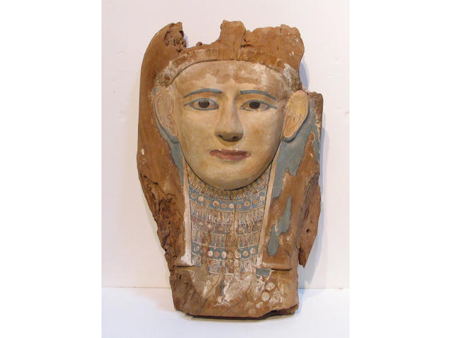 An Egyptian polychromed wood sarcophagus cover mask, (losses, painting refreshed)