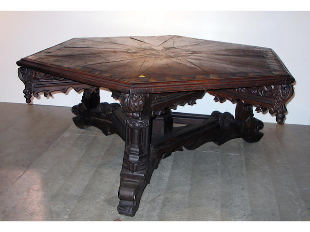 A Gothic Revival walnut and parcel ebonized center table
