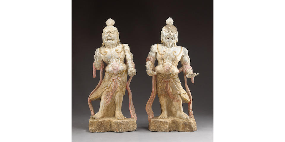 A pair of carved stone guardian figures