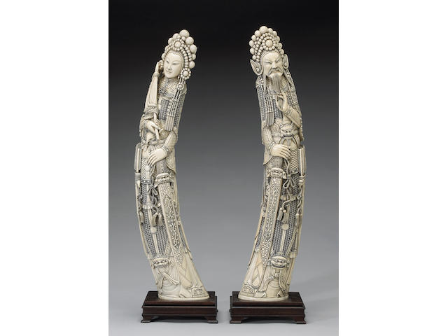 A pair of tinted ivory standing warriors (one chipped)