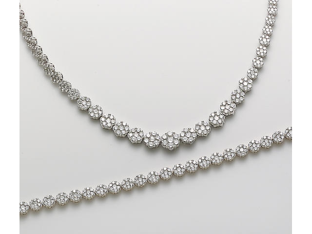 A set of diamond and 14k white and yellow gold jewelry including a necklace and bracelet