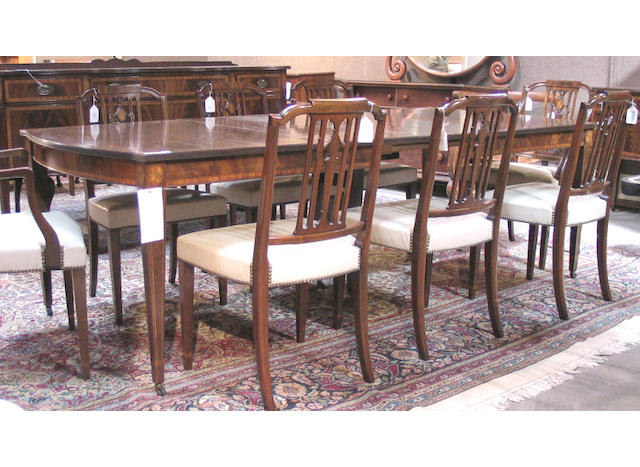 A Federal style inlaid mahogany dining suite comprising a table with four leaves, a sideboard, two armchairs and six side chairs