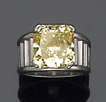 A natural fancy color diamond and platinum ring