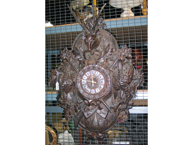 A large Black Forest carved walnut wall clock