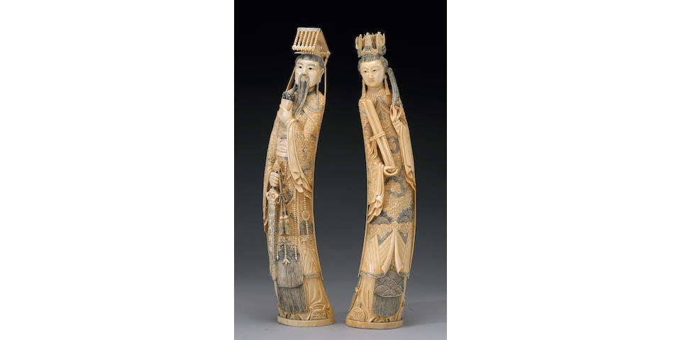 A pair of tinted ivory emperor and empress figures