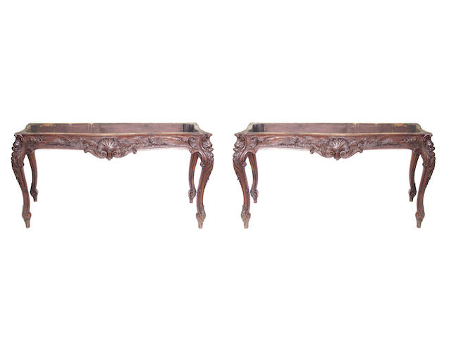 A pair of Louis XV style carved oak tables with carved aprons on cabriole supports
