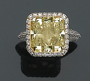A natural fancy color diamond, diamond and eighteen karat white gold ring