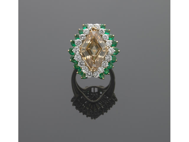 A fancy colored diamond, diamond, emerald, eighteen karat gold and platinum ring