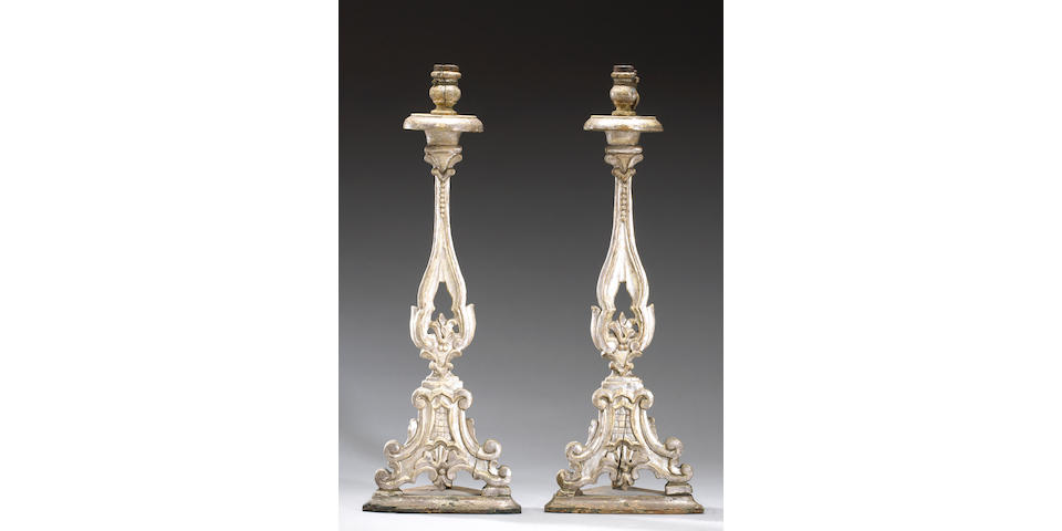 A pair of Italian silvered wood candlesticks
