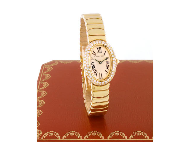 Cartier. A Ladies 18k gold and diamond set oval cased quartz bracelet watchBaignoire, recent