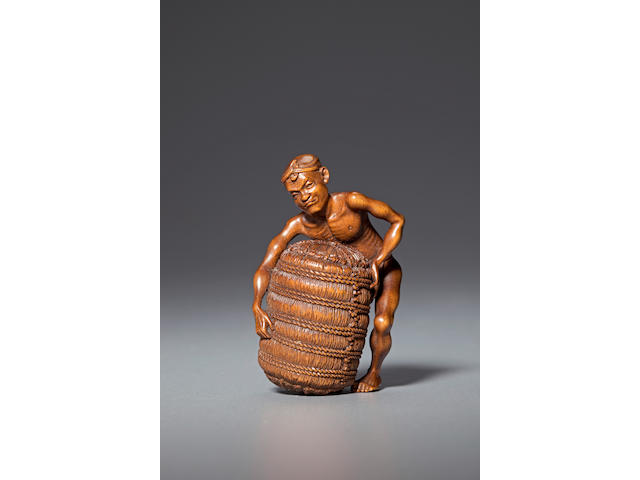 Wood netsuke of a workman with rice bale By Morita Soko (Tokyo, 1879-1943)