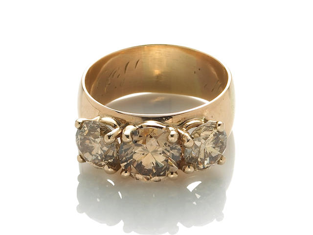 A colored diamond three stone ring