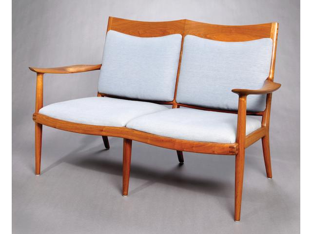A Sam Maloof two seat Walnut settee