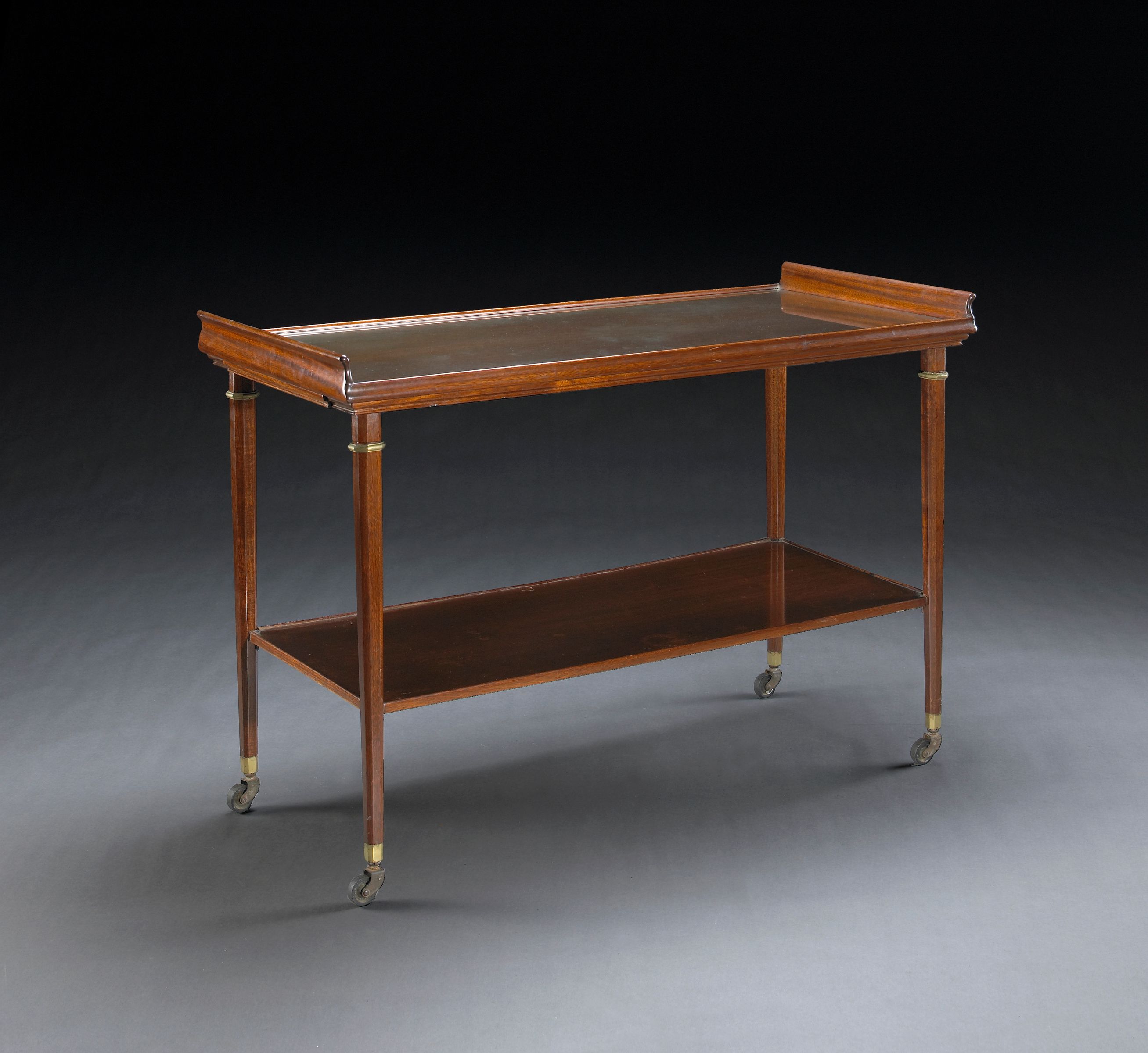 A mahogany two-tier serving table