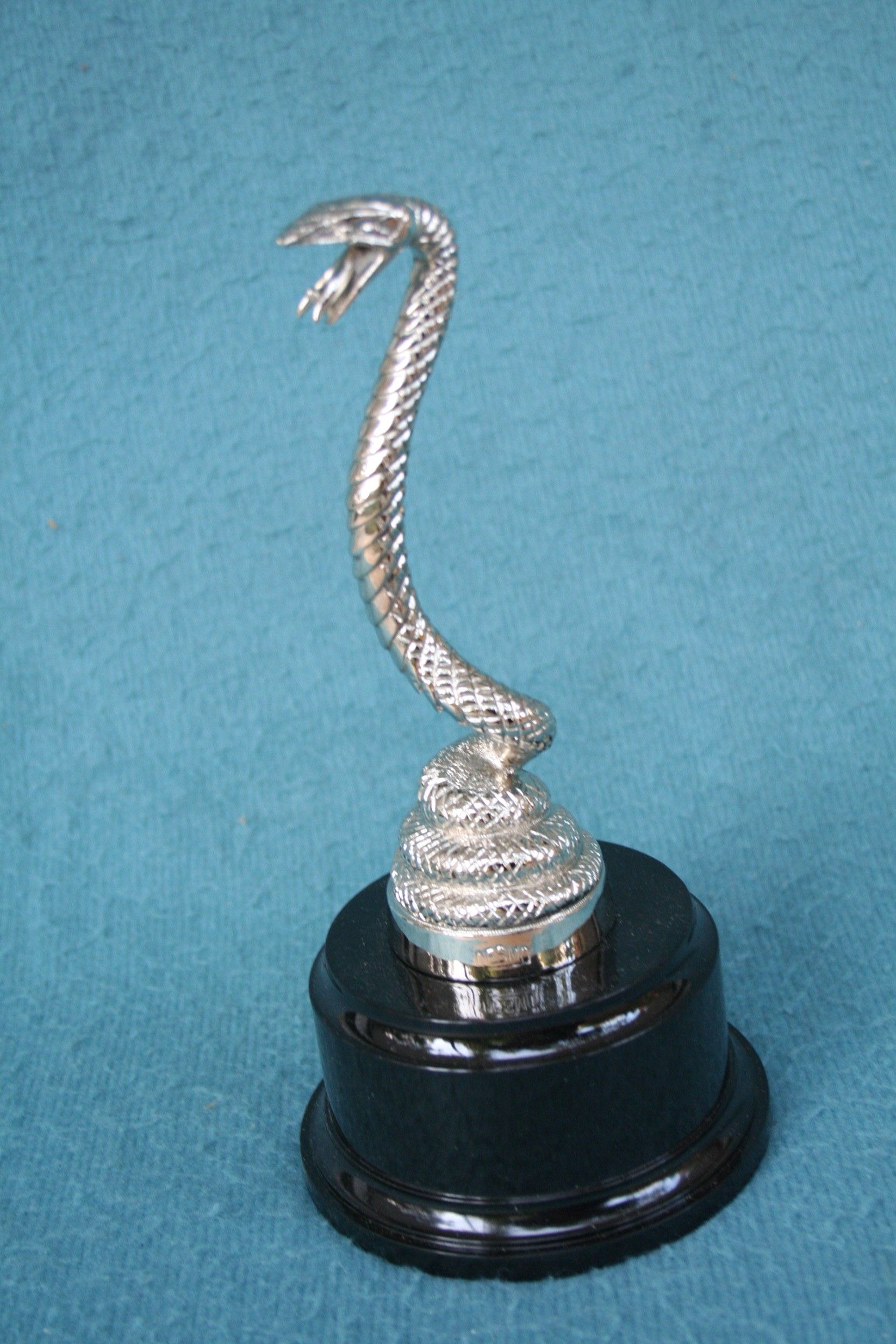 Bonhams Cars A 'Coiled Serpent' mascot by Desmo, British, 1930s, height 6in