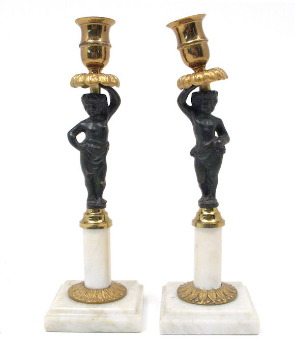Bonhams : A pair of Empire style gilt and patinated bronze candlesticks