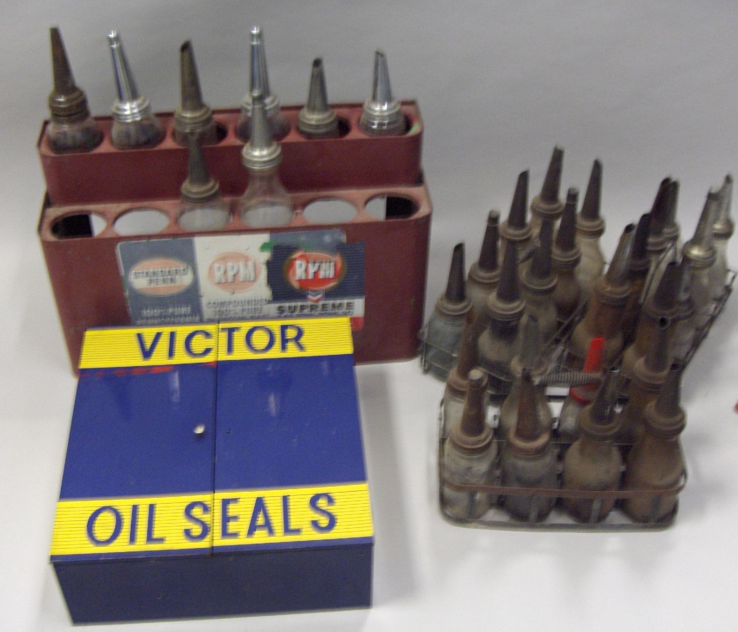 Bonhams Cars : A group of four oil bottle racks and a Victor Oil Seals ...