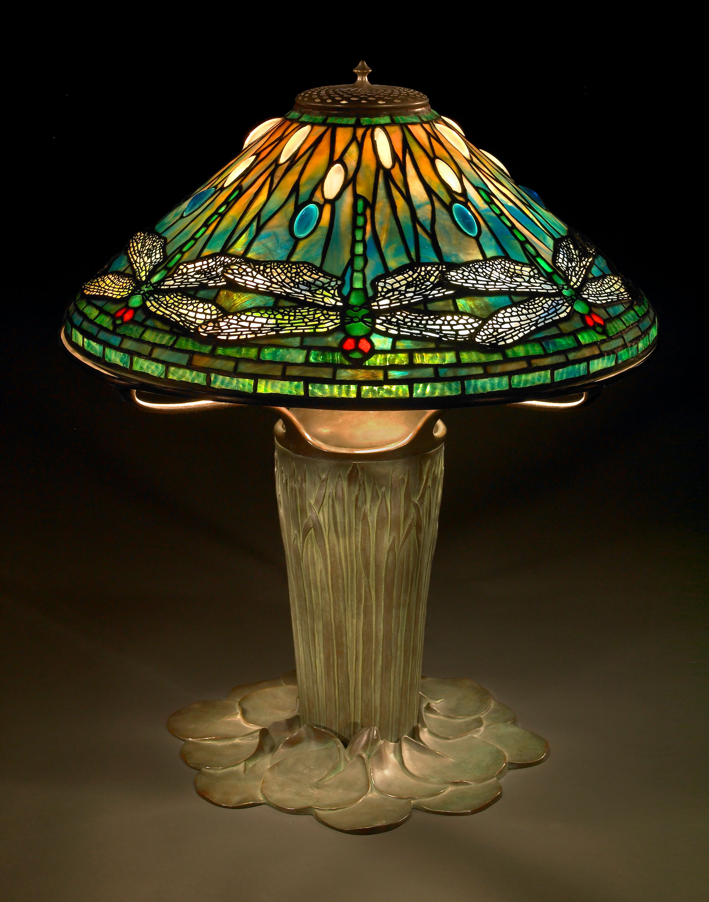 A Fine Tiffany Favrile glass and bronze dragonfly lamp on a catt