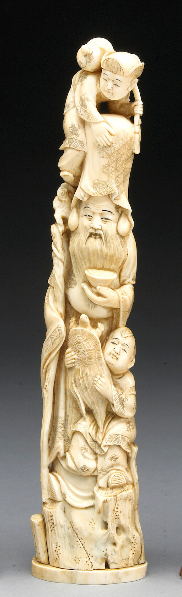 Bonhams : A carved and tinted ivory figural group of Fukurokuju and ...