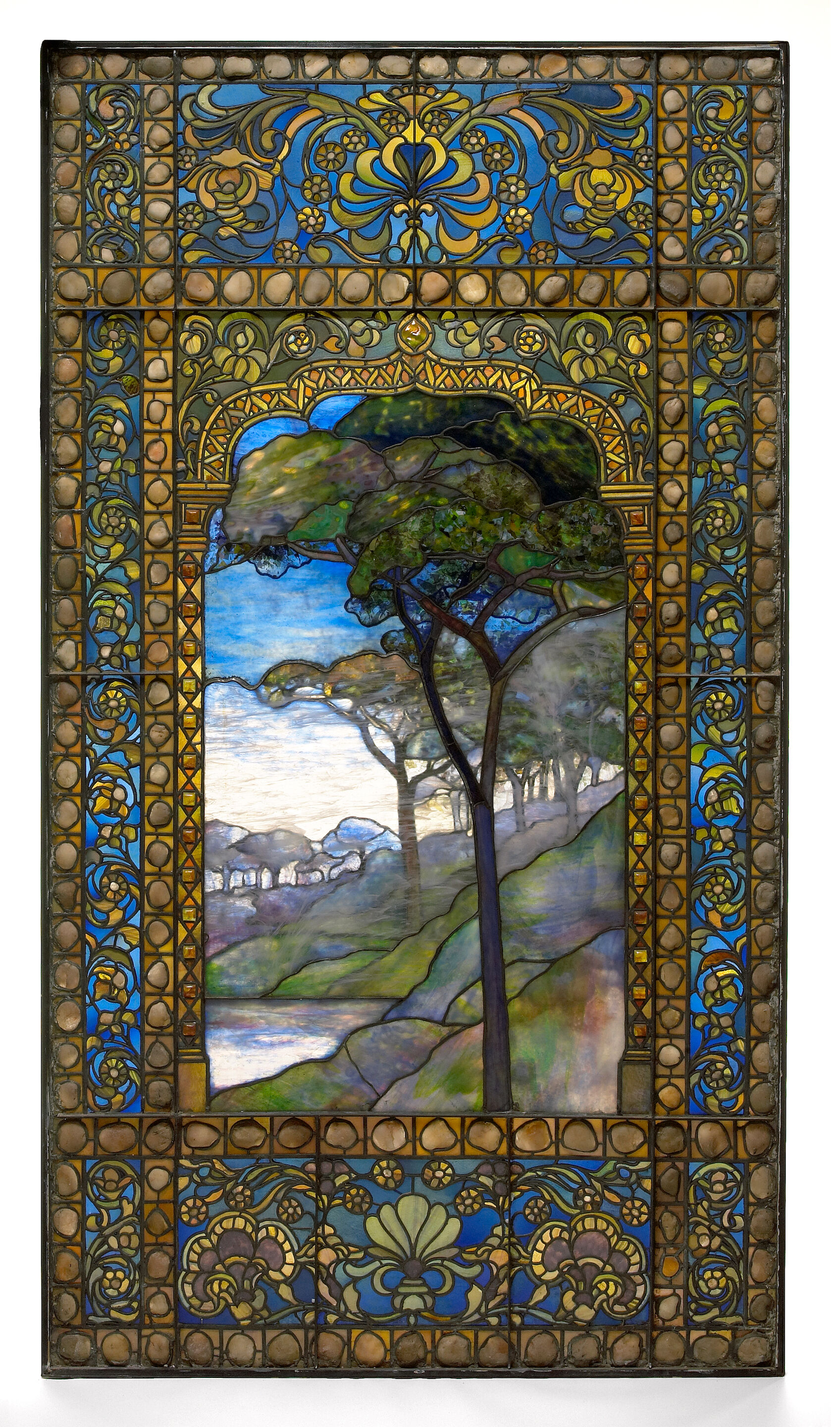 A good Tiffany leaded Favrile glass and pebble landscape window