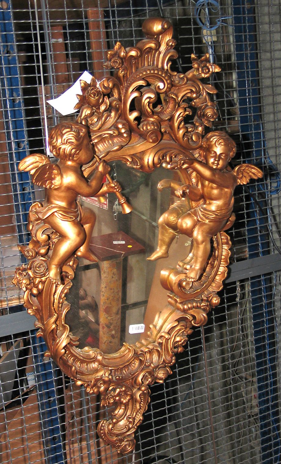 A Rococo style gilt composition mirror