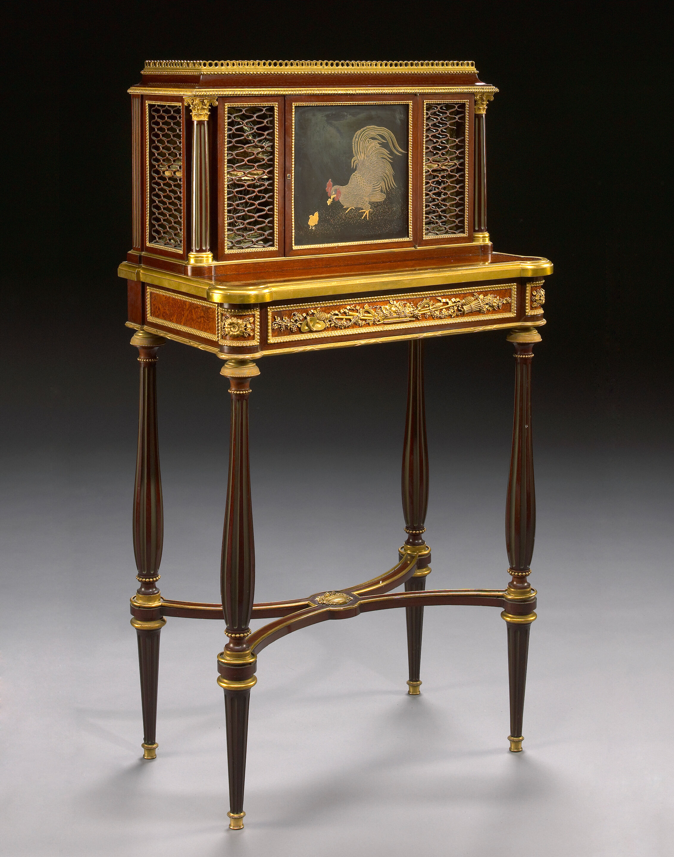 A Louis XVI style gilt bronze mounted amboyna inlaid mahogany bo