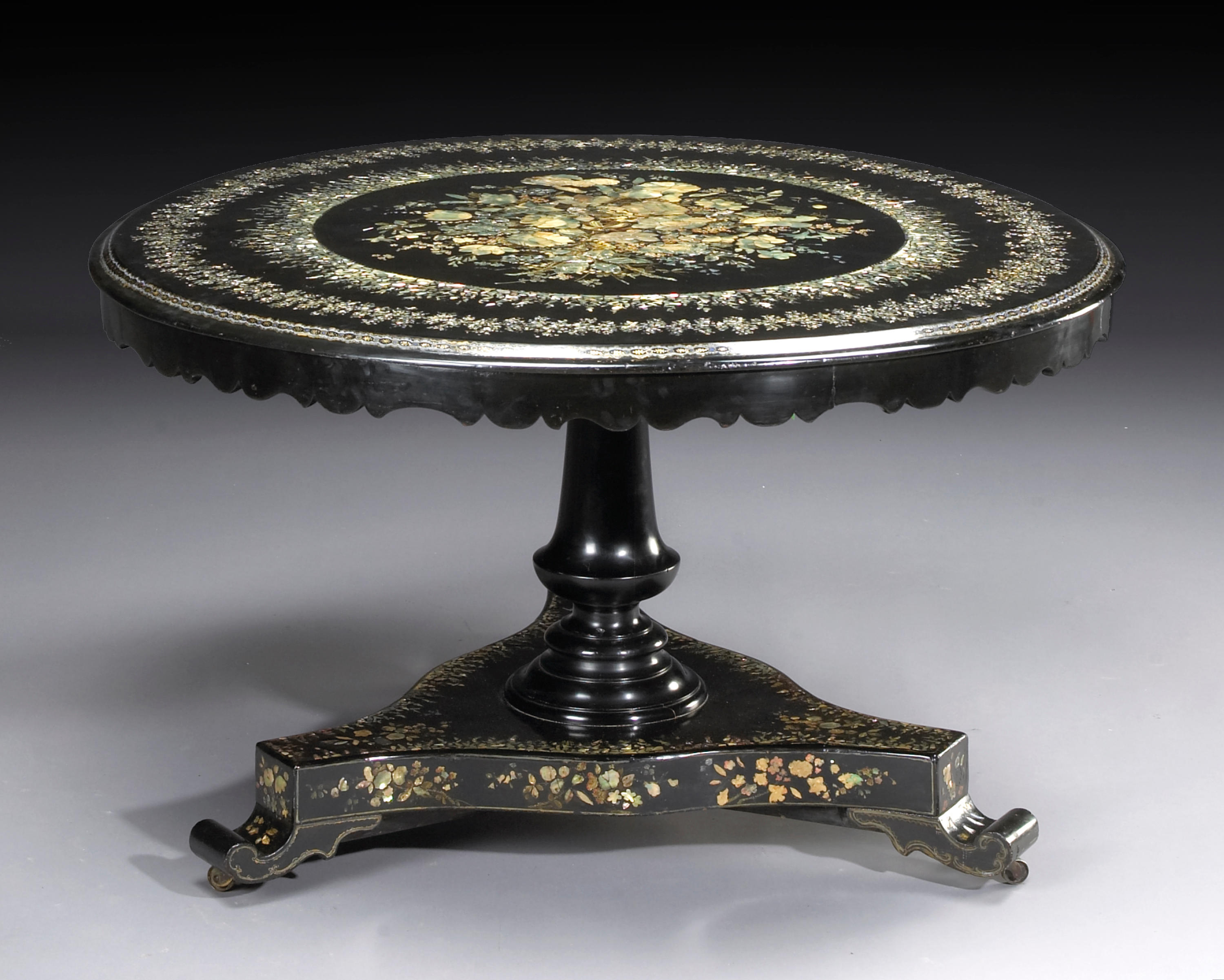 A Victorian shell inlaid and ebonized breakfast table