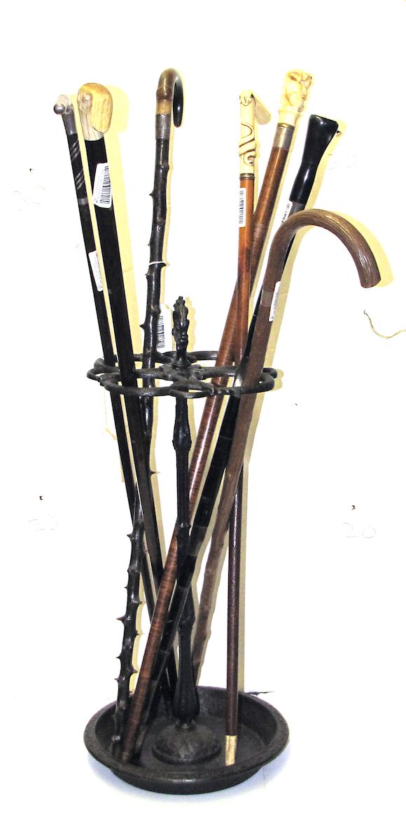 Bonhams Seven walking canes and a cast iron stand late 19th/early