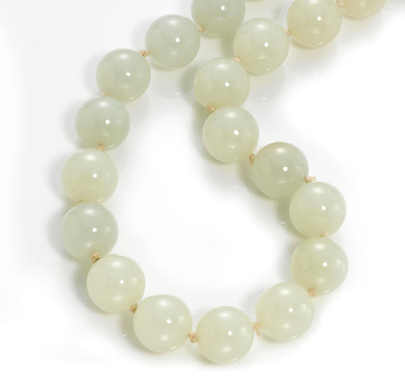 Bonhams : A pale celadon-white nephrite jade bead necklace