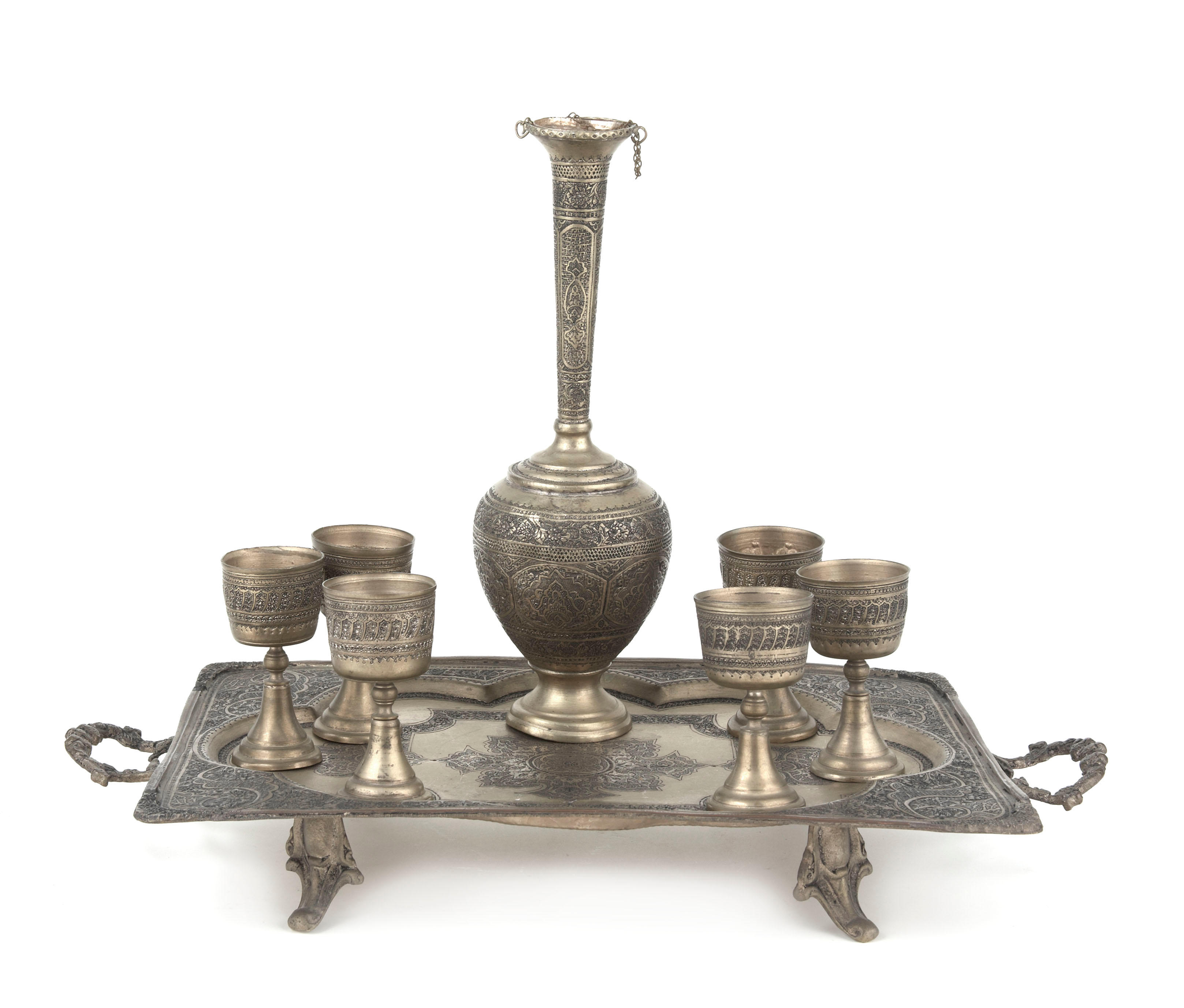 A Continental hammered brass cordial set