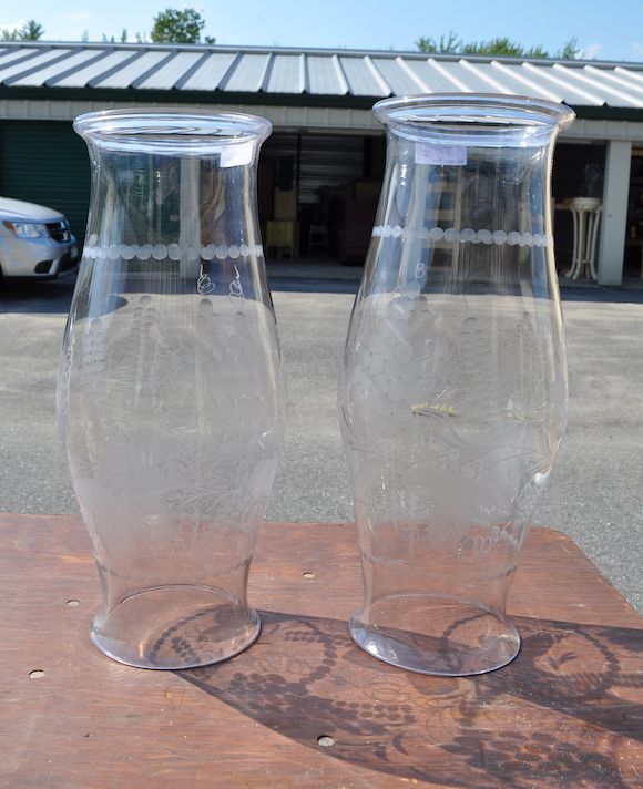 Bonhams A pair of large clear glass hurricane shades 20th century