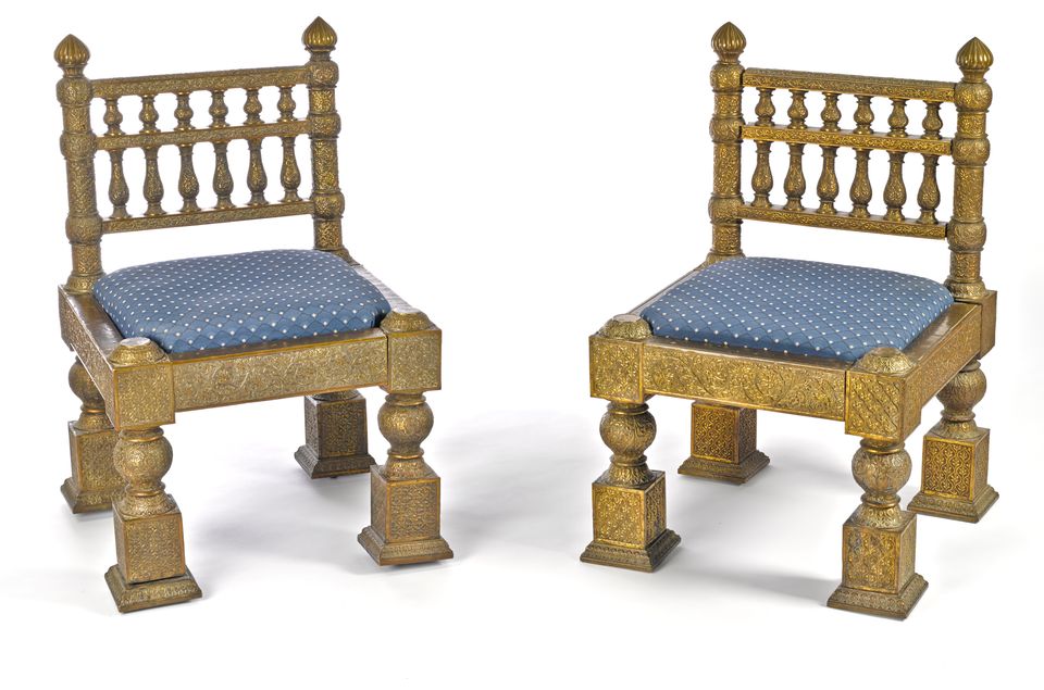 Bonhams A pair of chased brass overlaid teak side chairs designed by