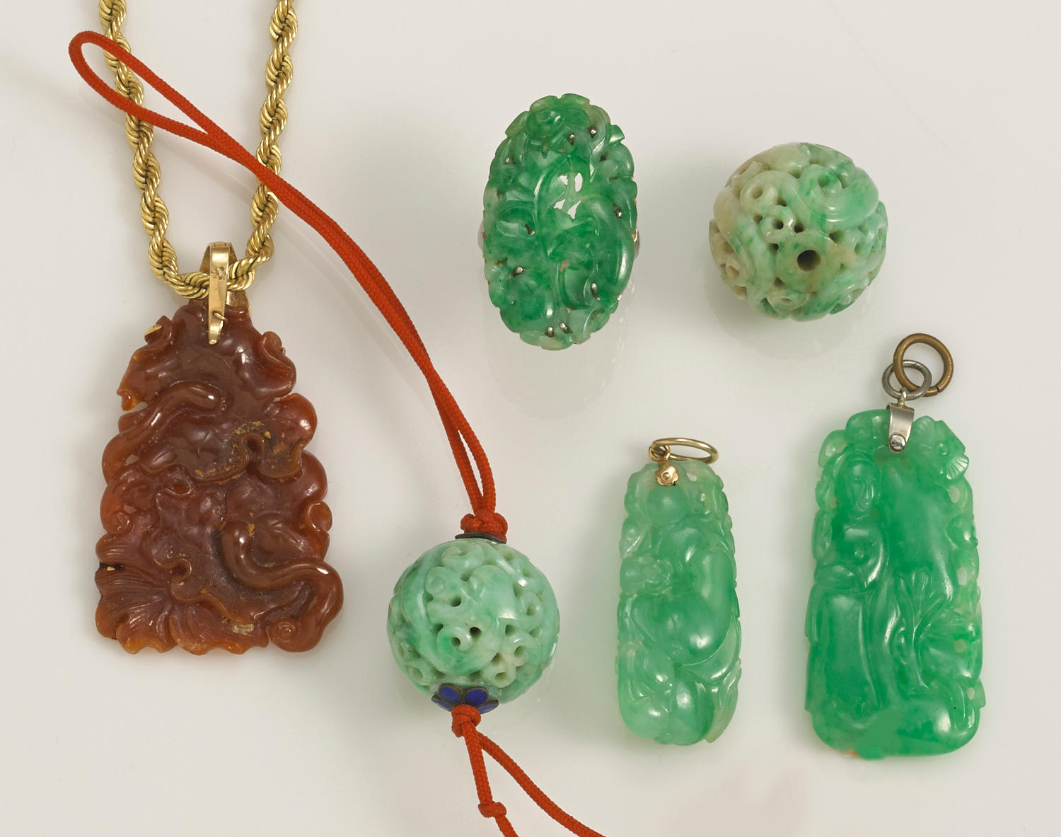 A collection of jadeite jade, 14k and 10k gold jewelry and jewelry components