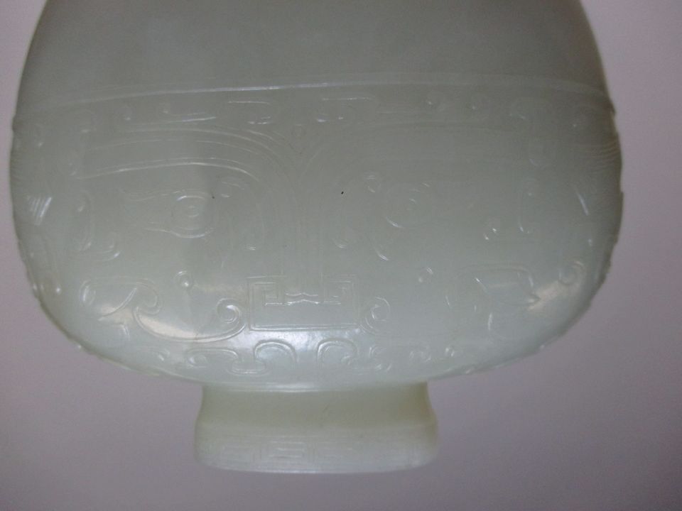 Bonhams A fine archaistic very pale greenishwhite jade vase Qianlong