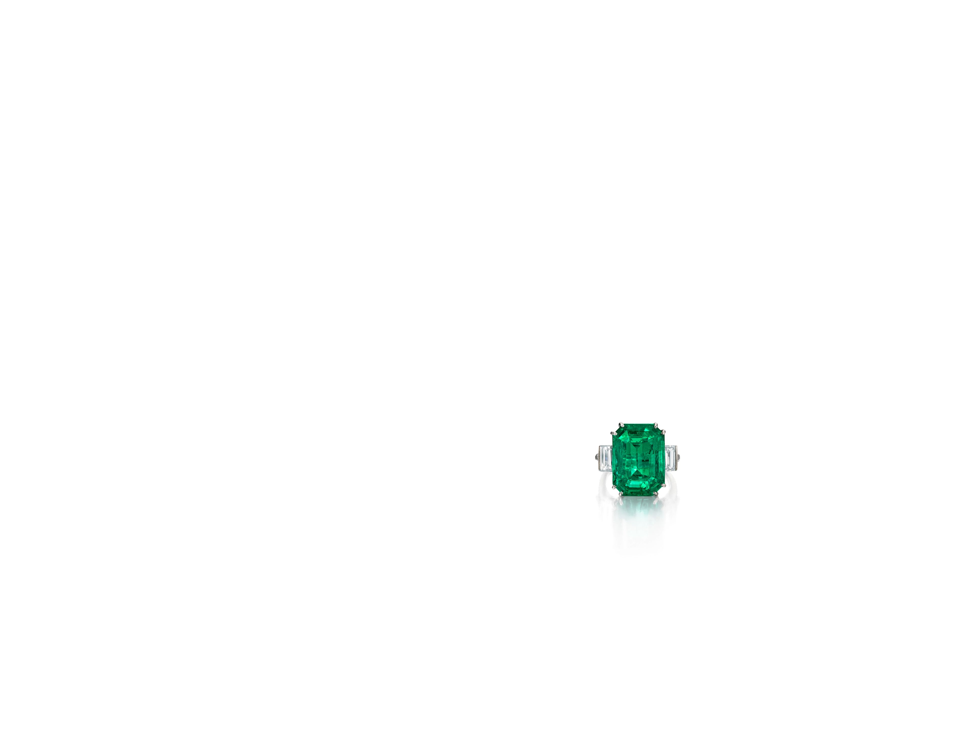 An emerald and diamond ring