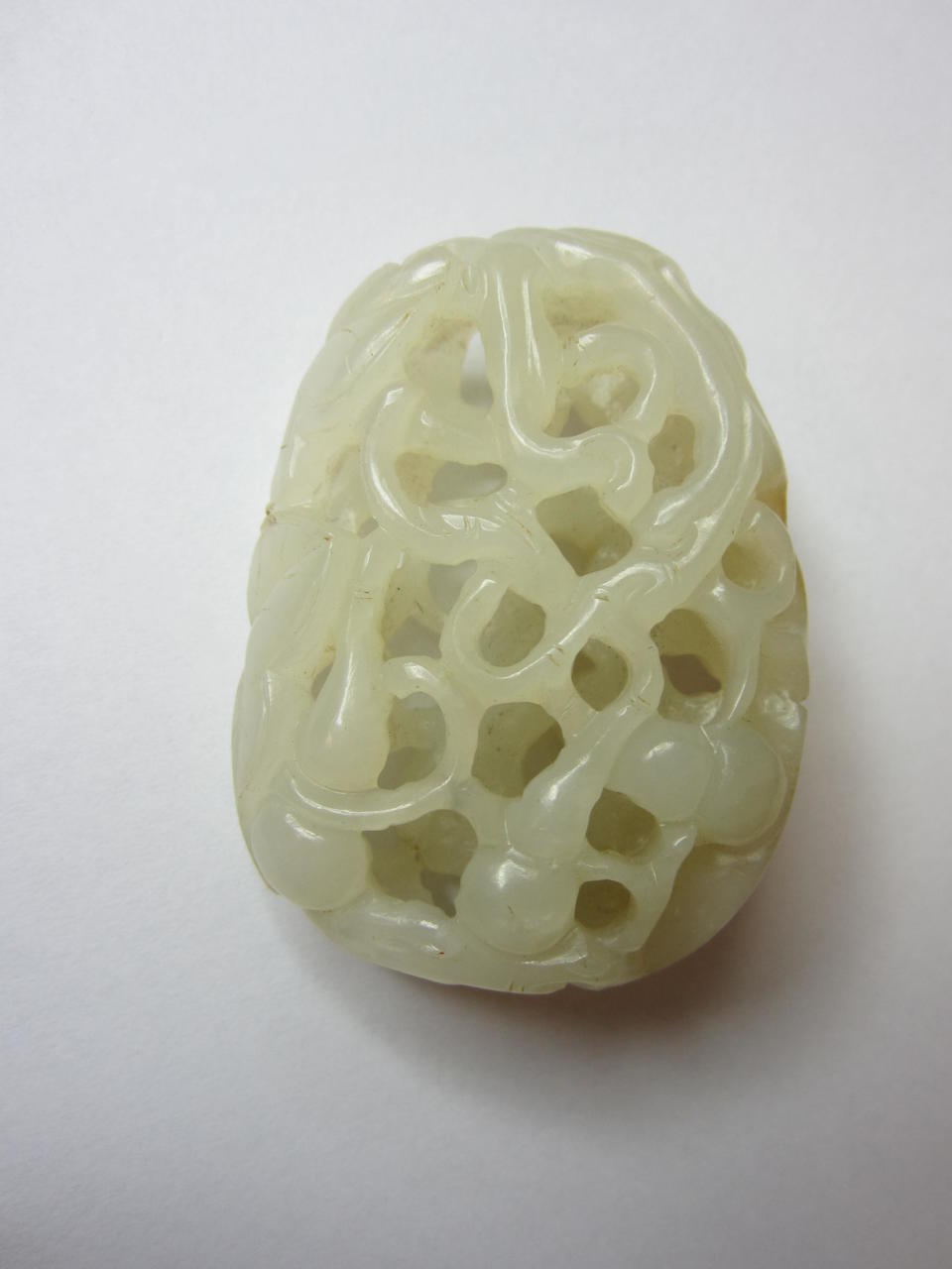 Bonhams : A reticulated white jade pendant