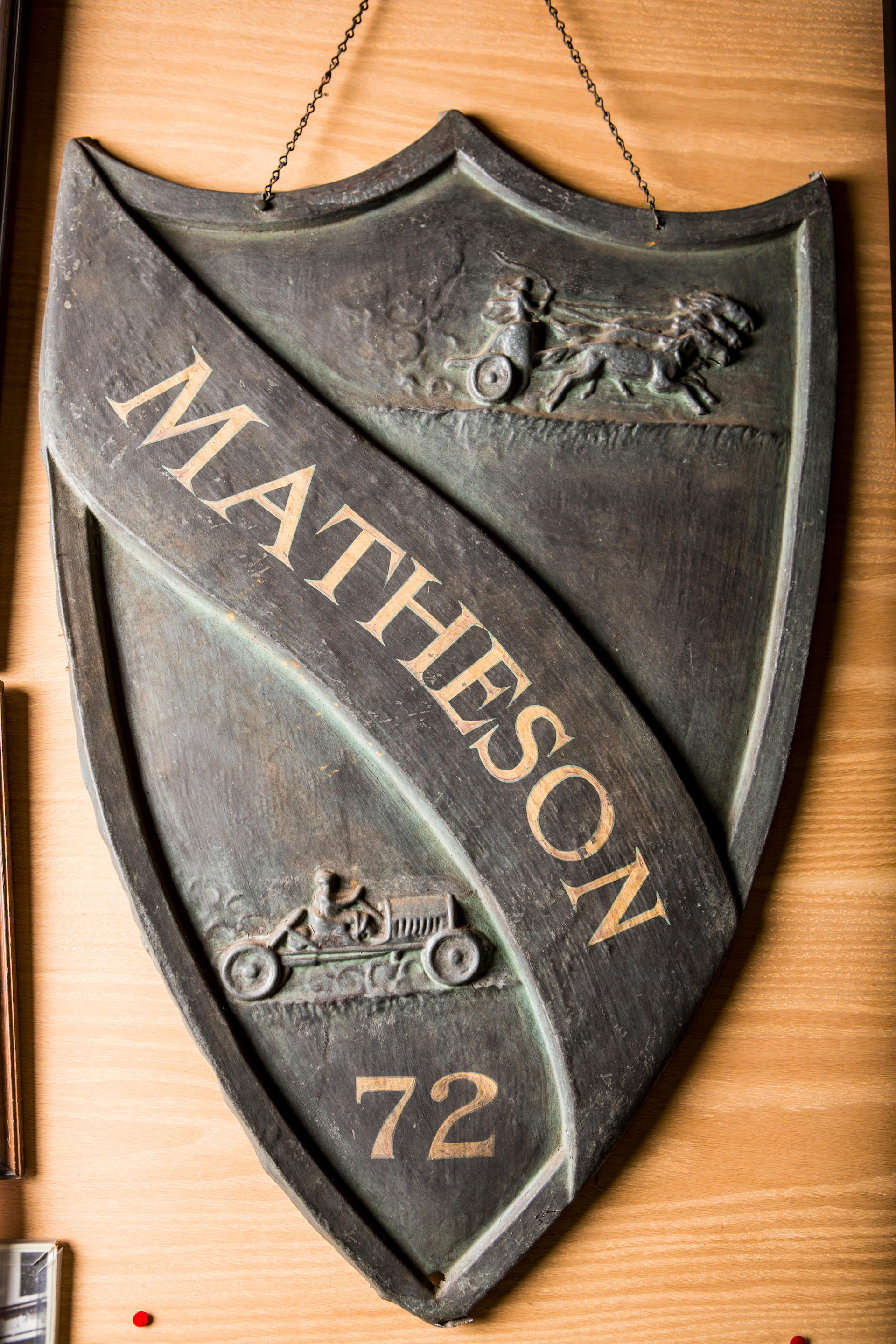 Bonhams Cars AN EMBOSSED TIN ADVERTISING SHIELD FOR THE MATHESON