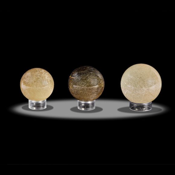 Bonhams Three Rutilated Smoky Quartz Spheres