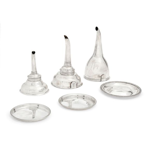 Bonhams THREE SILVER WINE FUNNELS AND UNDER TRAYS by various