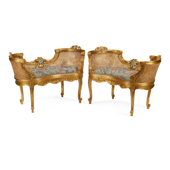 Bonhams : A PAIR OF LOUIS XV STYLE CARVED GILTWOOD AND CANED PETITE SETTEES