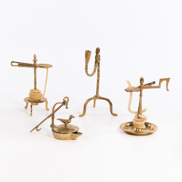 Bonhams Skinner Four Early Brass Lighting Devices, probably England