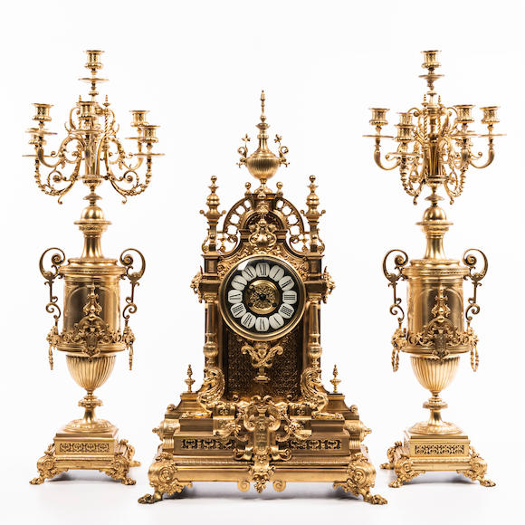 Bonhams Skinner Three Piece Monumental Gilt Brass Clock Garniture 