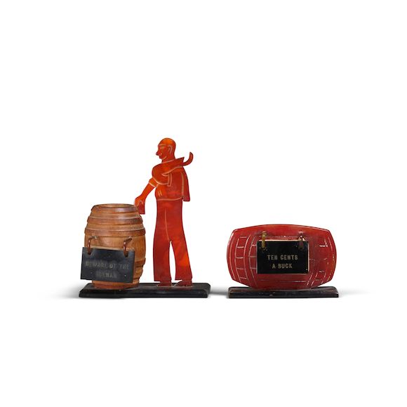 bonhams-two-bakelite-figural-recipe-stands-with-a-red-barrel-stand