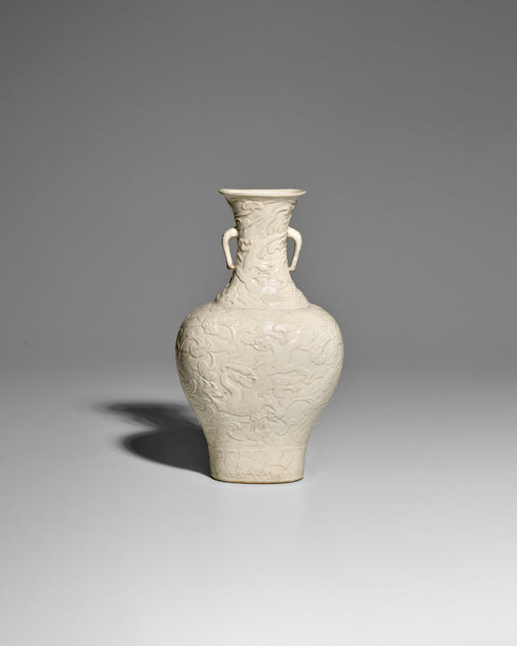 Bonhams : AN UNUSUAL WHITE-GLAZED SOFT PASTE MOLDED 'DRAGONS AND ...