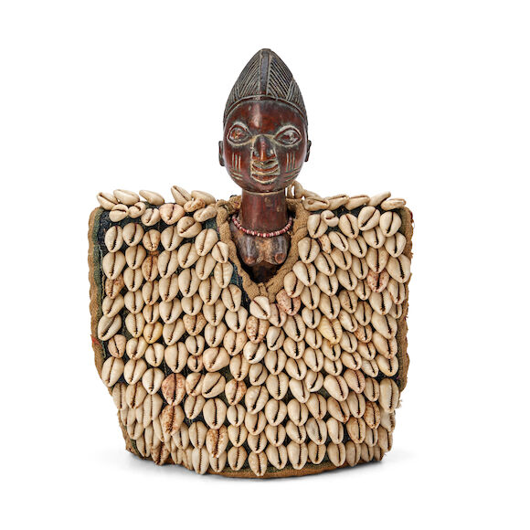 Bonhams Skinner : A female Yoruba Ibeji doll with cowrie shells ht. 10 ...