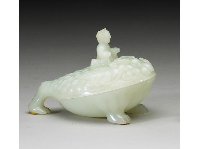 A carved white jade covered box in the form of Liu Hai riding on his toad