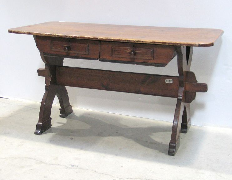 A Continental stained pine trestle table
